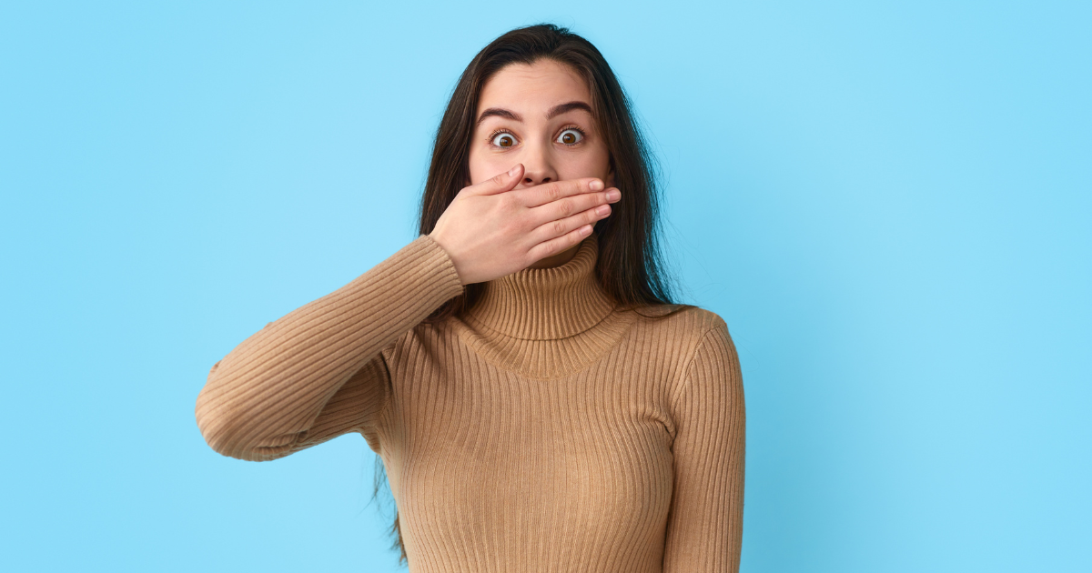 Woman covering her smile with her hand