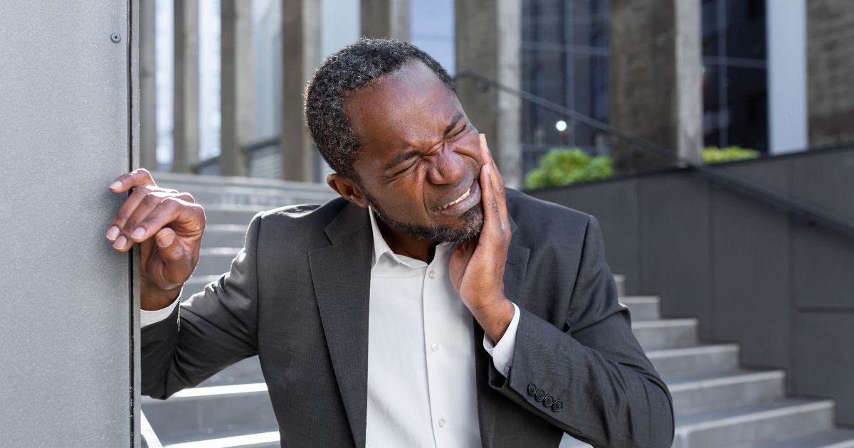 Man holding his jaw in pain