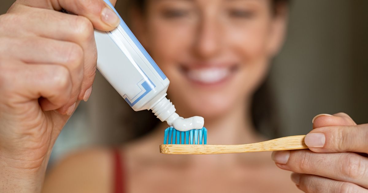 Whitening toothpaste being applied to a toothbrush