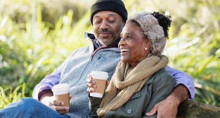 Couple drinking coffee together outdoors