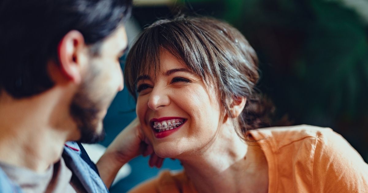 Adult woman smiling with braces