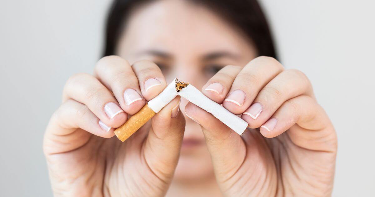 Woman breaking a cigarette in half