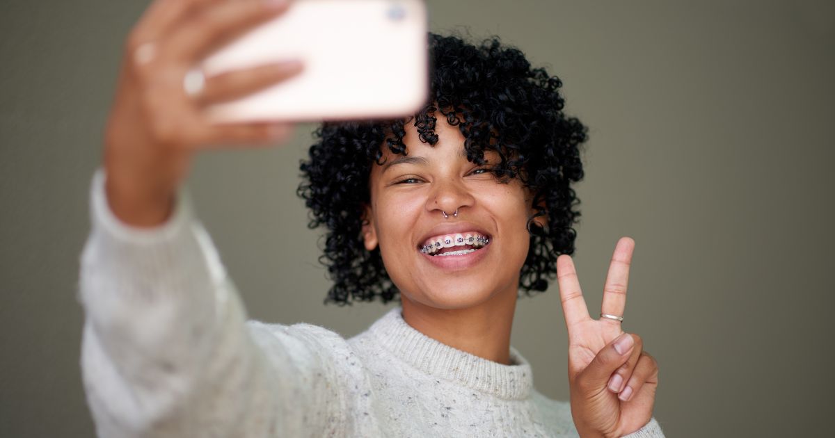 Woman with braces taking a selfie
