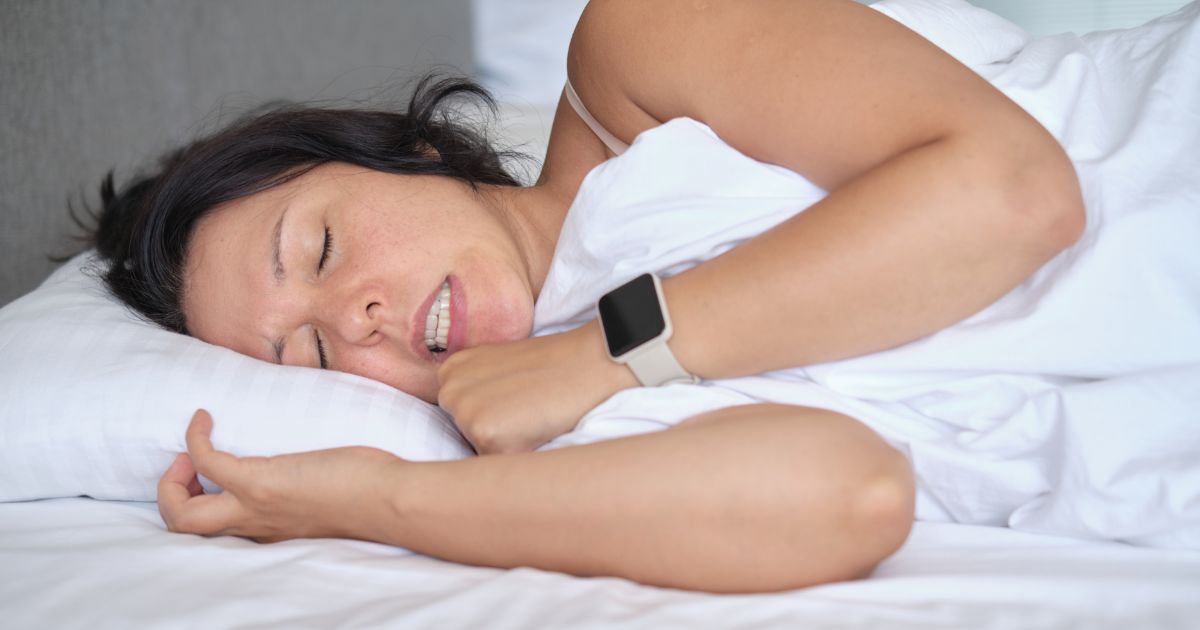 Woman grinding her teeth while sleeping