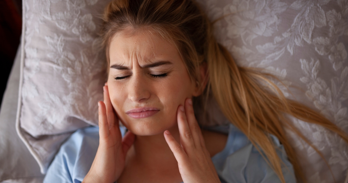 Person experiencing head and neck discomfort