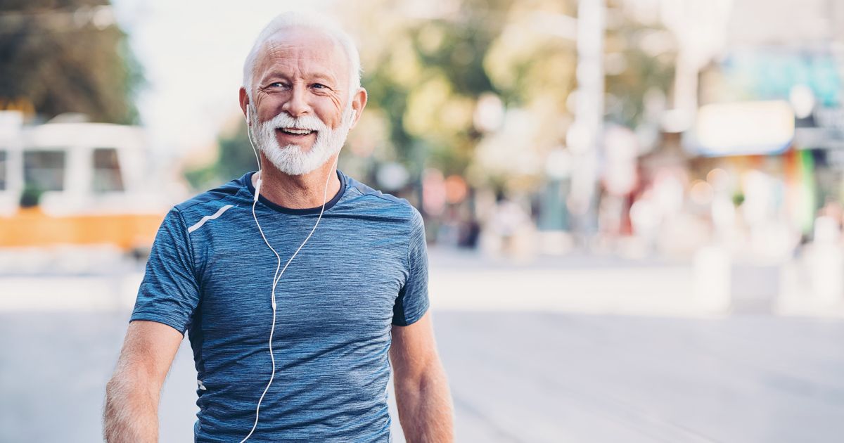 Man smiling while walking outdoors