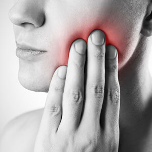 Person experiencing jaw and mouth discomfort
