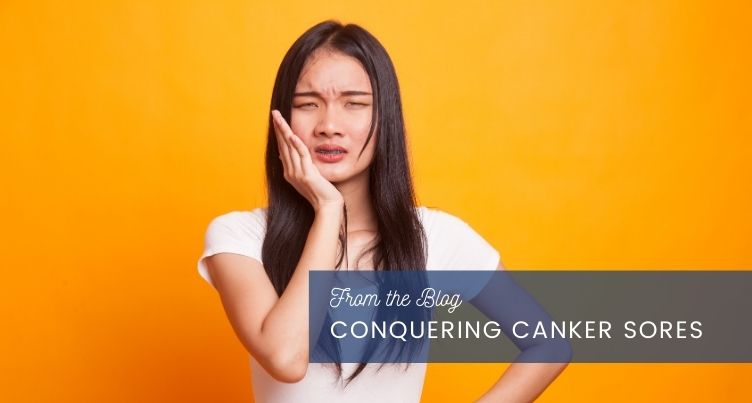 Woman holding her jaw in discomfort