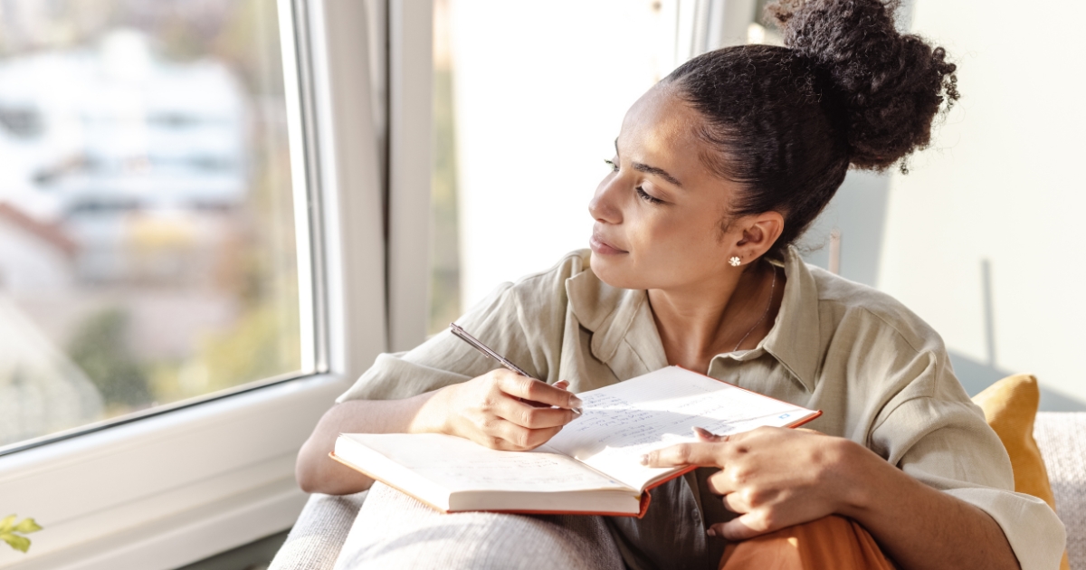 Person writing goals in a journal