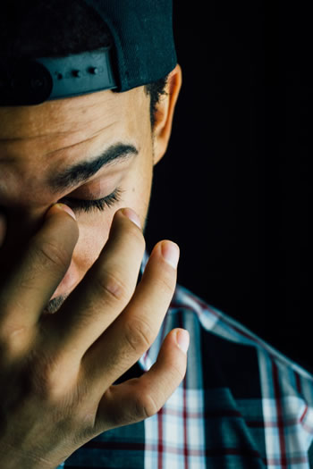 Person holding their temples with headache pain