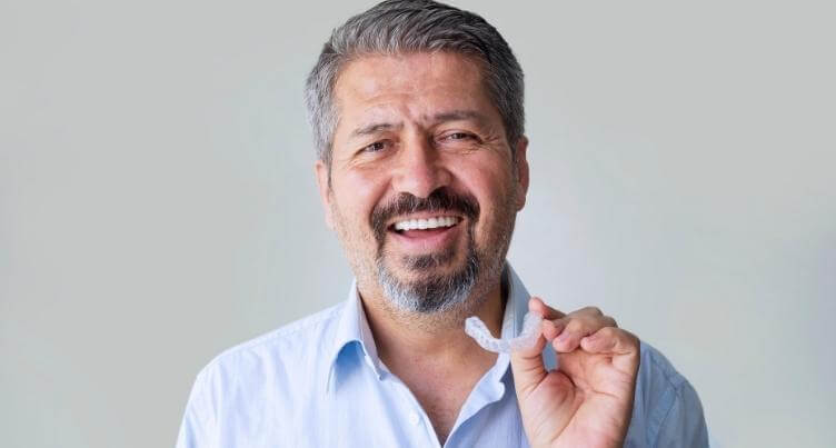 Man holding a custom dental night guard