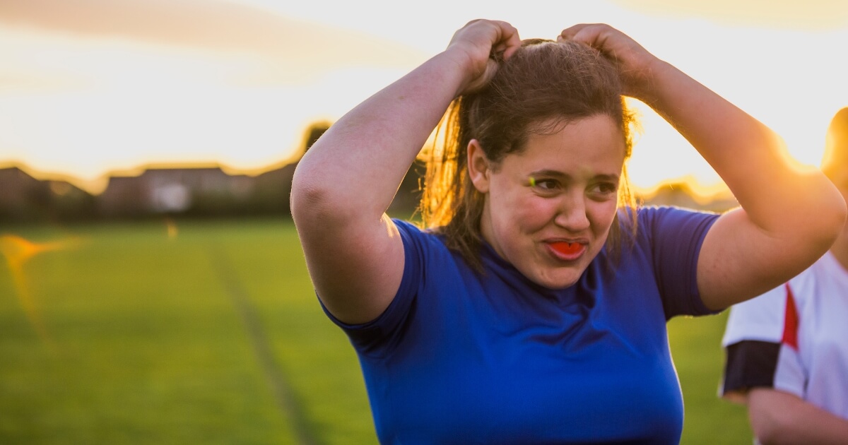 Female athlete wearing a sports mouthguard