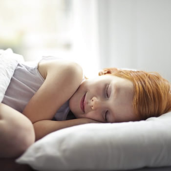 Child asleep in bed