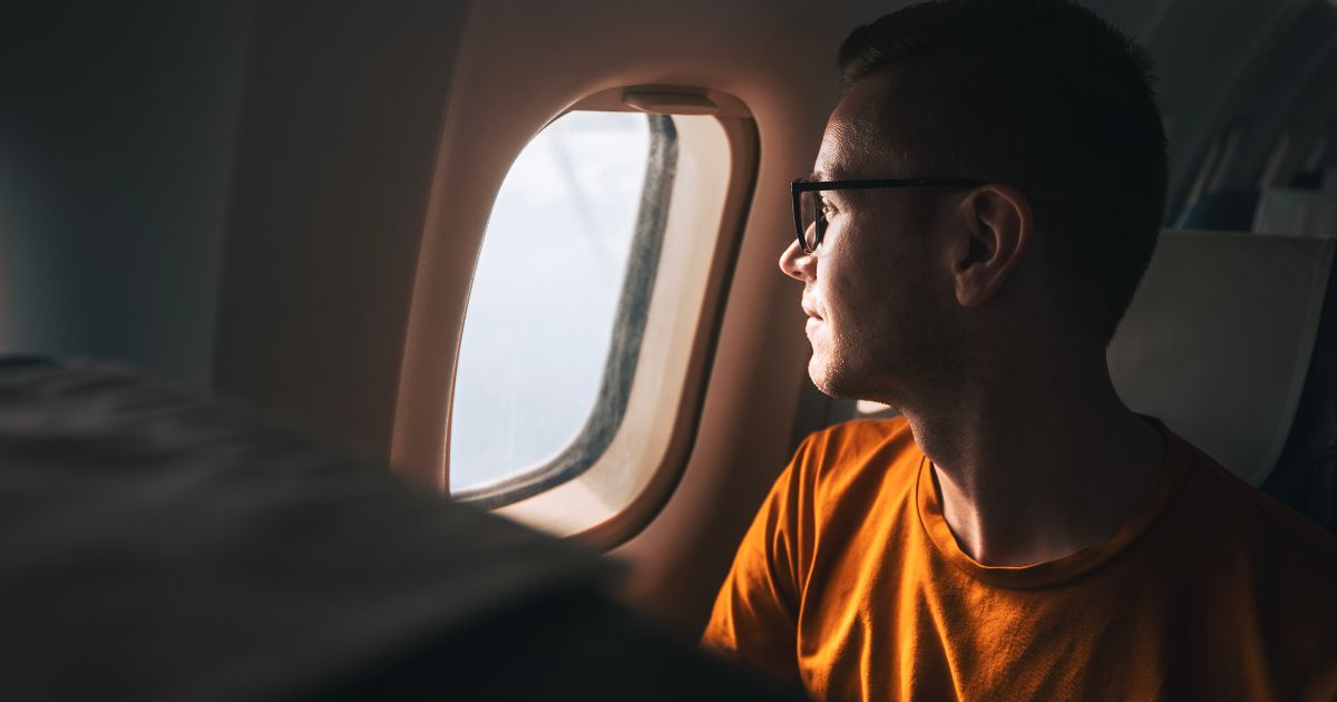 Man looking out of an aeroplane window
