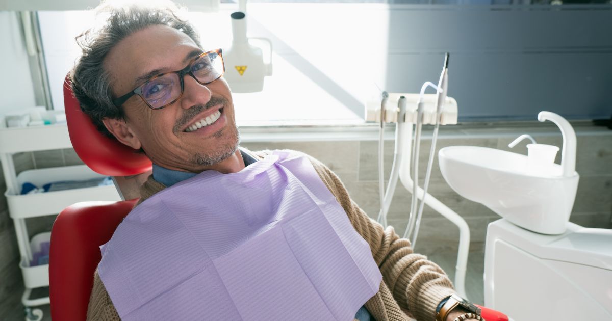Man smiling in a dental chair