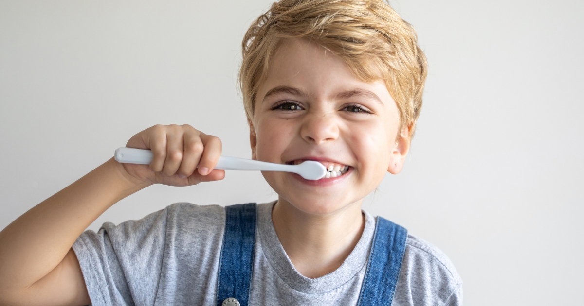 Child brushing their teeth with fluoride toothpaste