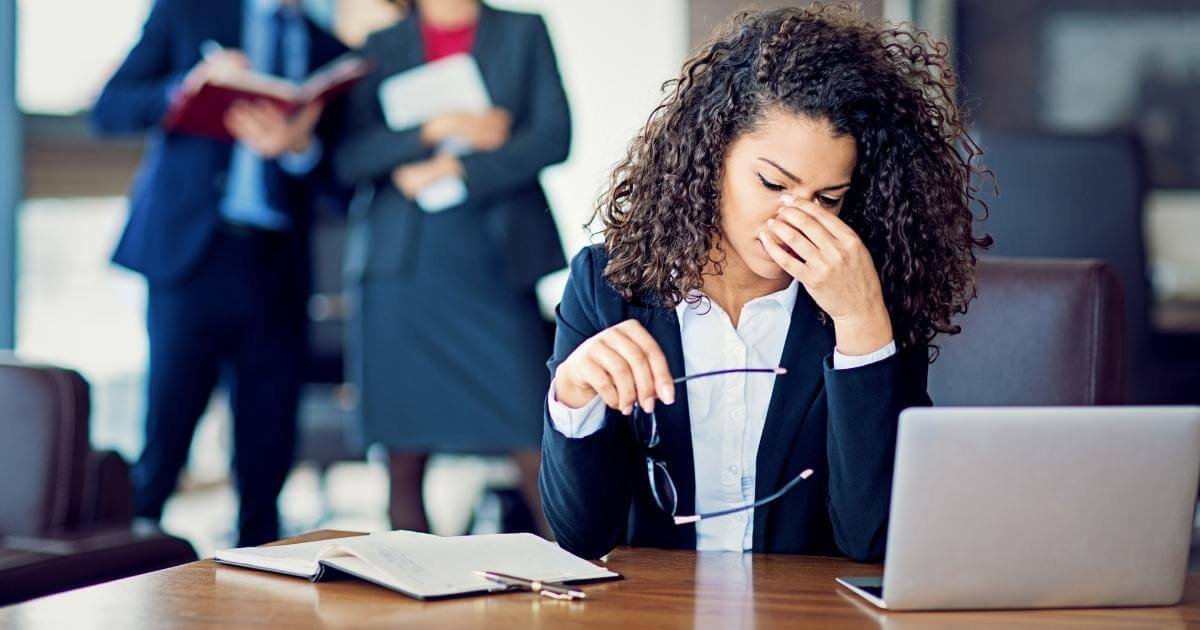 Stressed woman working at her desk