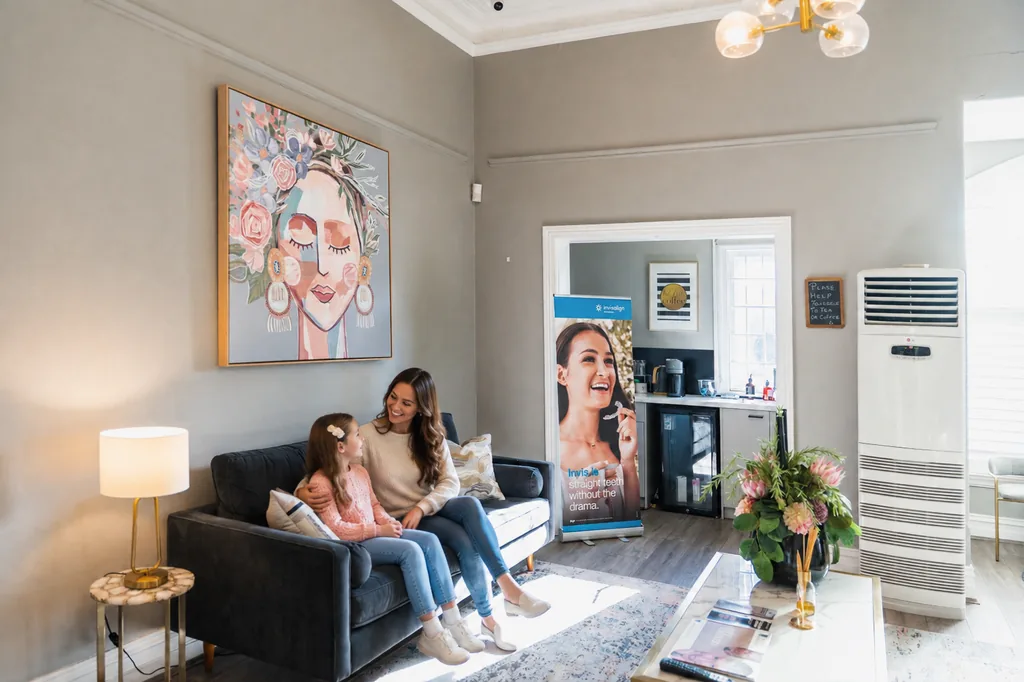 Parent and child waiting in the family lounge at TMJ Therapy Centre Toorak